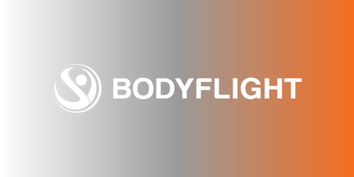 TradevenueBF Bodyflights logotyp med en bakgrund som skiftar i grått och orange. Köp ett Bodyflight presentkort